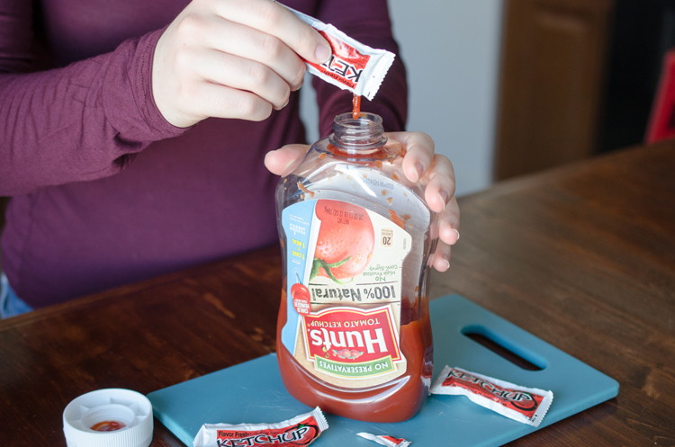 Save restaurant condiment packets and squeeze them into the containers at home.